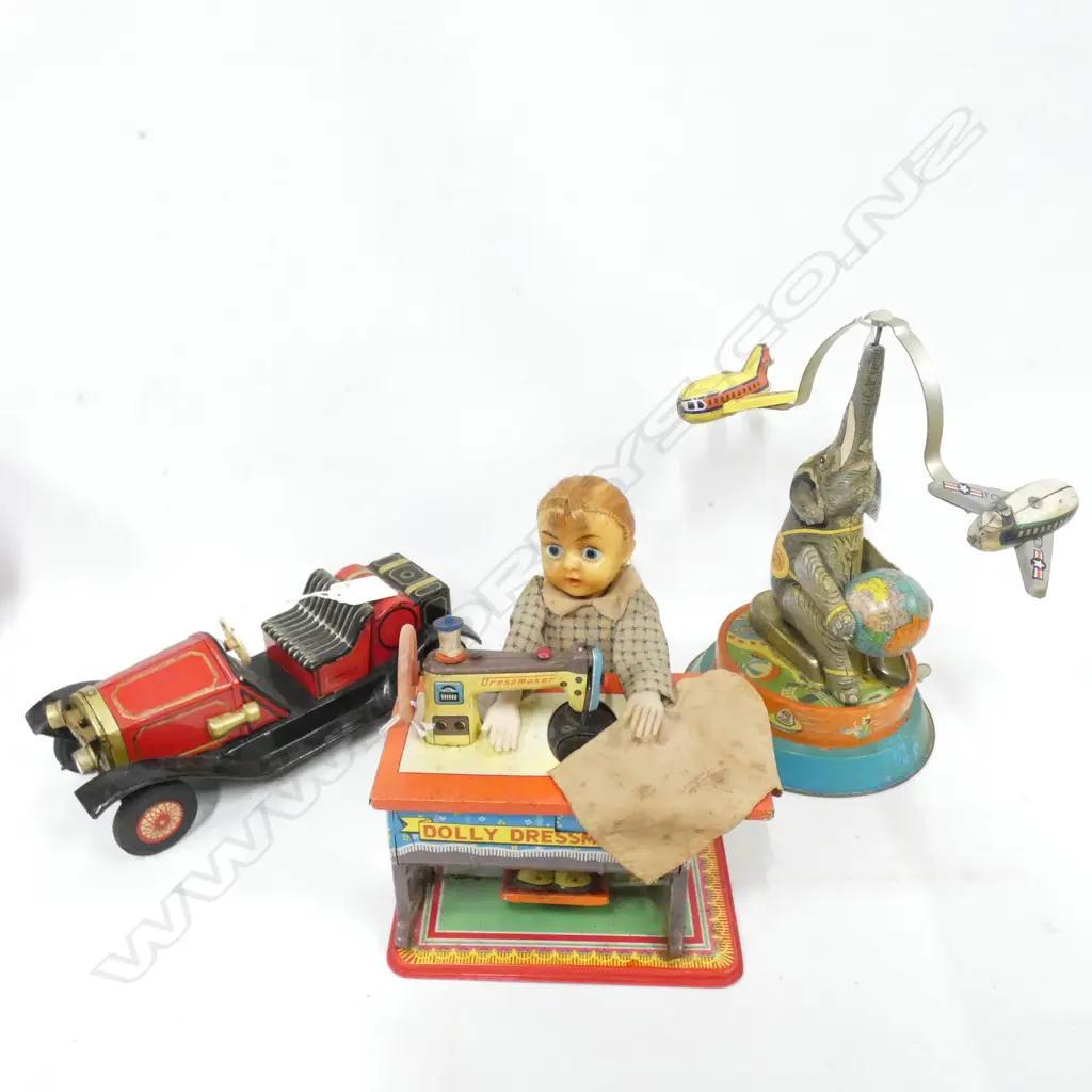 THRE TIN PLATE TOYS; 1 BATTERY OPERATED DOLLY DRESSMAKER  /CRAGTON 1914 RED CAR & CIRCUS ELEPHANT BALANCING 2 PLANES Image 1++